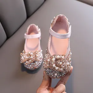 Elegant pink girls' dress shoes with sparkling rhinestone bow for dance and performance