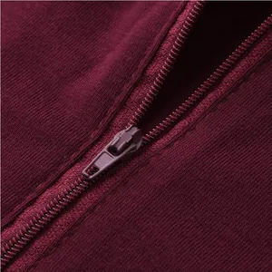 Macro view of a durable burgundy zipper and fabric texture on a mens casual romper outfit