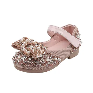 Elegant sparkly girls' Mary Jane flats with decorative bow, crystals and pearls for dance