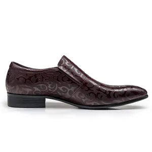 Detailed side view of men's burgundy leather dress shoe with embossed floral pattern