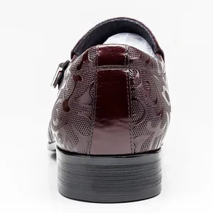 Detailed rear view of handmade burgundy leather dress shoe featuring embossed patterns.