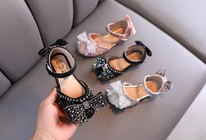 Detailed view of sparkly rhinestone girls' princess shoes with bow accents in various colors