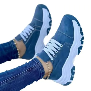 Women's blue suede-like platform sneakers with thick white soles and white lace-up design
