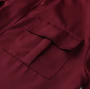 Close-up view of the cargo pocket detail on a burgundy men's loose casual jumpsuit uniform