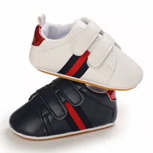 Pair of premium white and navy blue baby soft sole walking shoes with stylish striped straps