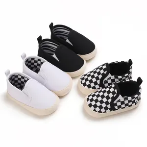 Collection of soft-sole slip-on baby walking shoes in black, white, and checkered patterns.