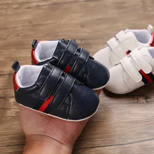 Close-up of navy blue infant leather walking shoes with soft soles and velcro straps