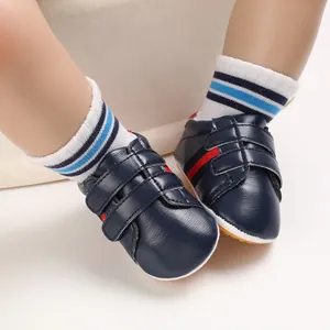 Close-up detail of navy blue baby leather walking shoes with soft non-slip soles
