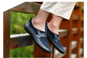 Detail view of navy blue breathable mesh slip-on loafers for men in outdoor setting