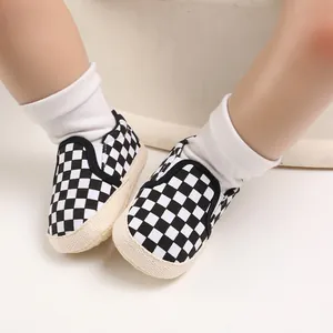 Close-up of baby slip-on walking shoes with classic black and white checkerboard pattern