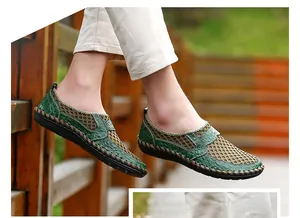 Detailed side view of green and beige breathable mesh loafers for men on wooden bridge