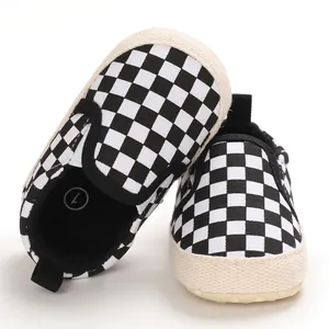 Close-up of black and white checkerboard baby walking shoes with soft soles