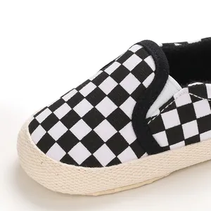 Detailed macro view of baby slip-on shoe featuring classic black and white checkerboard pattern