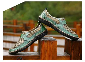 Detailed close-up side view of breathable green mesh slip-on casual shoes for men