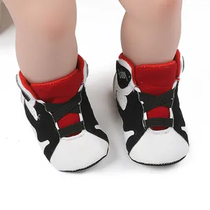 Close-up detail of baby walking sneakers with classic black and white color blocking