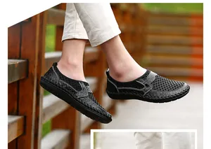 Close-up detail of black breathable mesh slip-on casual shoes for men in an outdoor setting