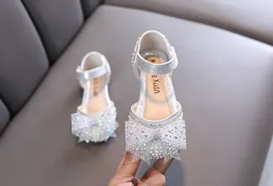 Sparkling silver girl's princess shoes with large rhinestone bow and pearl details
