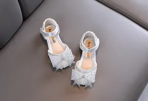 Sparkling silver girls' princess shoes with rhinestone and pearl bow detail