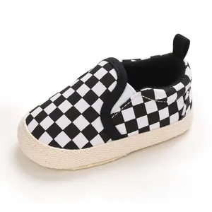 Detailed view of baby slip-on walking shoe with black and white checkered pattern