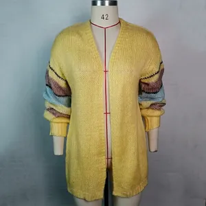 Detail van een geel mohair vest met kleurrijke gestreepte mouwen op een etalagepop