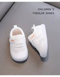 Detailed view of white toddler walking shoes with breathable mesh and velcro straps.