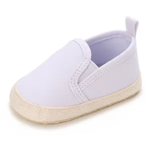 Close-up side view of white soft sole baby walking shoes for girls with woven details
