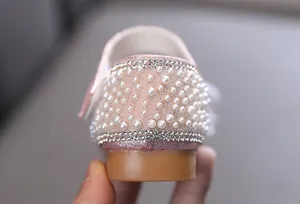 Detailed view of the pink princess shoes for girls featuring pearl and rhinestone accents