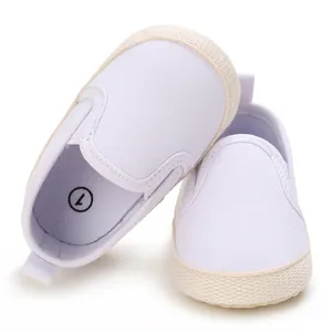 Detailed view of white infant canvas slip-on shoes with size 1 insole label