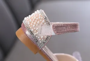 Detailed view of pink glitter girl princess shoe with elegant pearl and rhinestone accents