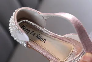 Detailed view of the insole and pearl heel of pink glittery girls' princess shoes.