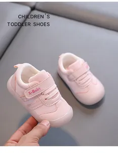 Detailed close-up of pink toddler walking shoes with velcro strap and mesh design