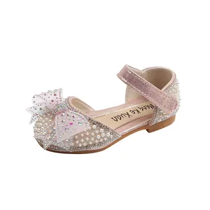 Pink princess dress shoes for girls with pearl and rhinestone bow decoration.