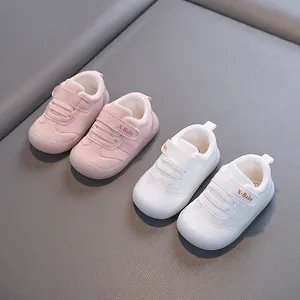 Toddler walking shoes featuring soft soles and adjustable velcro straps in pink and white