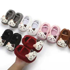 Detail of soft plush baby walking shoes with cute cartoon cat faces in multiple colors