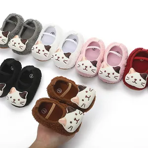 Close-up detail of soft plush infant pre-walker slippers with cute cartoon cat design