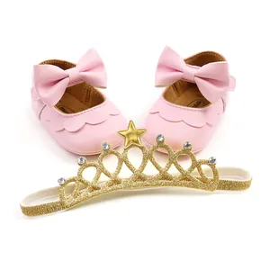 Pink baby princess shoes with large bow and golden glitter crown headband set for toddlers