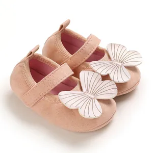Close-up detail of soft-sole pink baby princess walking shoes with butterfly décor
