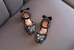 Detailed view of girl's black princess sandals with sparkling rhinestone butterfly design