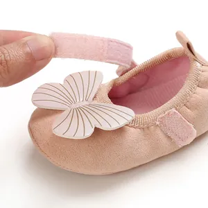 Detail shot of pink baby pre-walker shoe with adjustable velcro strap and butterfly