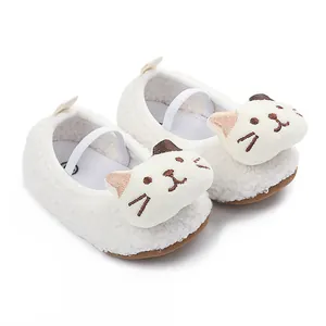 Detail shot of white sherpa baby shoes with cute 3D cartoon cat face decoration