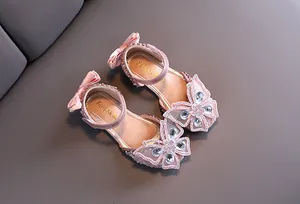 Detail view of pink girl's princess sandals with rhinestone butterfly and bow decoration