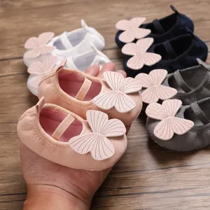 Detail showing soft sole baby walking shoes with decorative butterfly bows for infants