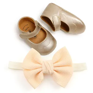 Detailed view of gold PU baby princess walking shoes and peach bow headband set for infants