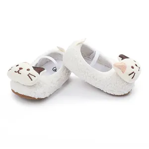 Close-up detail of white fleece baby walking shoes with cute 3D cartoon cat design