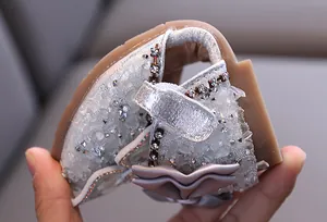 Flexible soft sole of girls' silver rhinestone sandals showing comfort