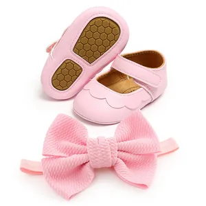 Pink baby girl walking shoes set with soft soles and matching oversized bow headband.