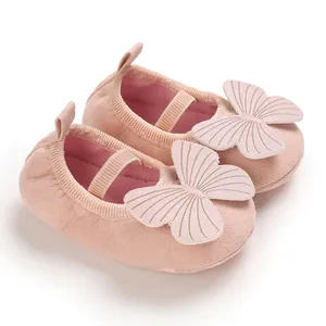Close-up view of pink baby girl soft sole walker shoes with large butterfly decoration