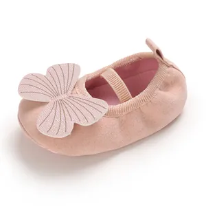 Detail of soft-soled pink baby girl shoe with large decorative butterfly wings