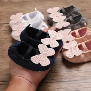Detail of soft sole baby girl walking shoes with butterfly detail in navy and pink