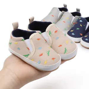 Soft canvas baby pre-walker shoes with cute dinosaur prints and elastic slip-on design.